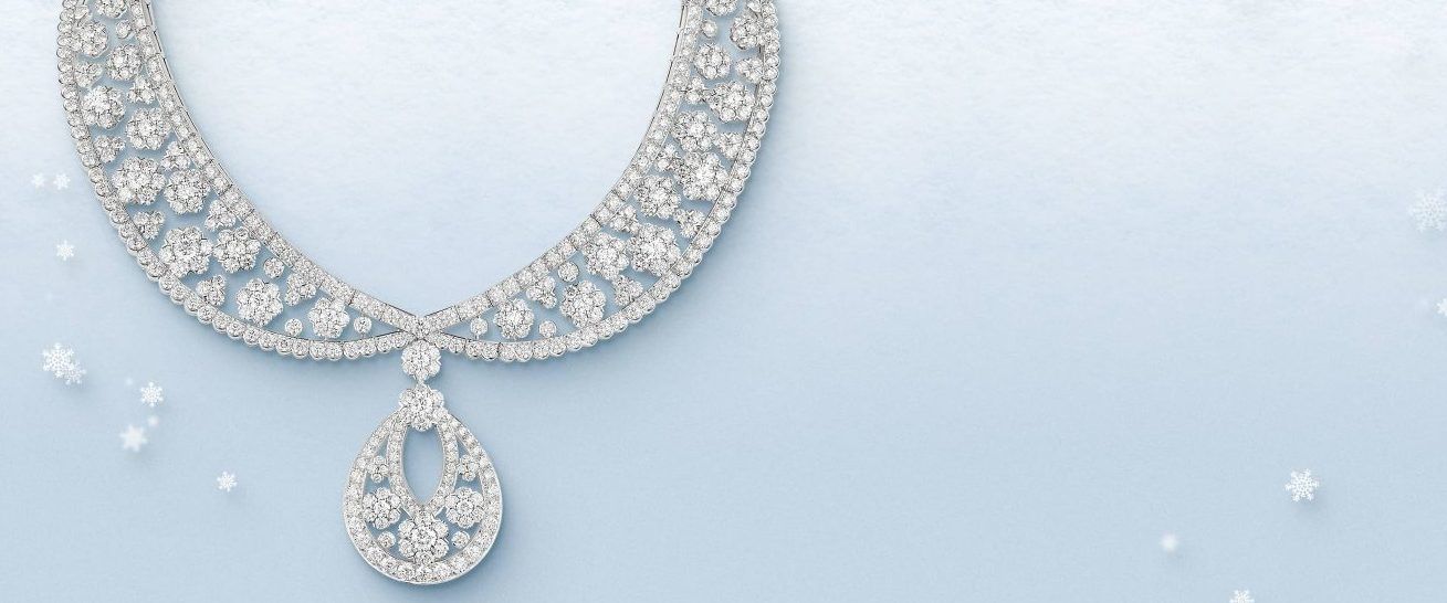 Nathalie Jordan, head of the jewellery department, takes a closer look at a  Tiffany & Co platinum and diamond snowflake pendant, which is displayed  at Bonhams, Edinburgh, before it is offered at