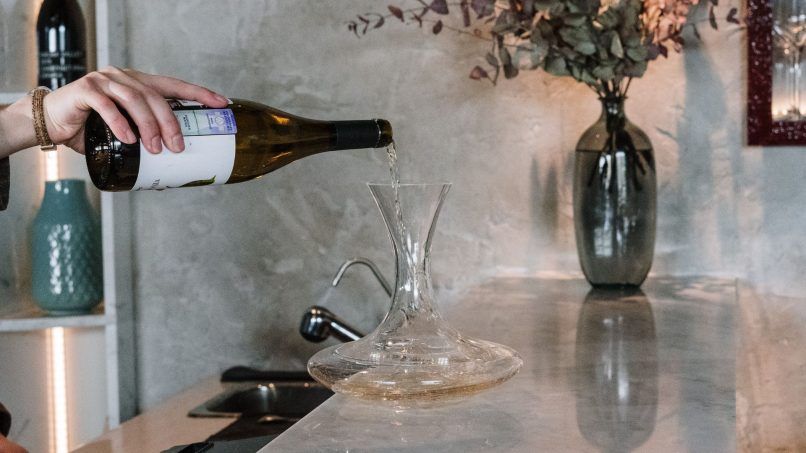 Pouring white wine in a decanter