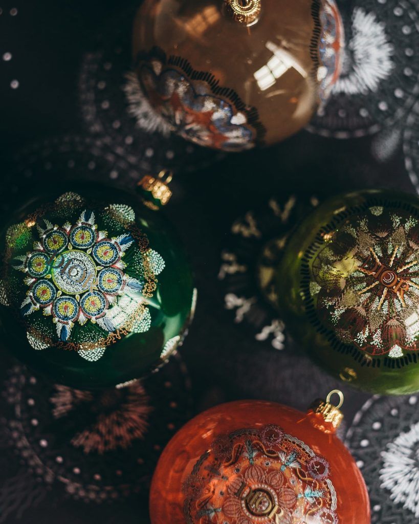 The collection includes four different Christmas glass ornaments featuring Luminarie patterns. Embroidered cushions from the Dior Maison collection. (Photo credit: Ines Manai, courtesy of Dior)