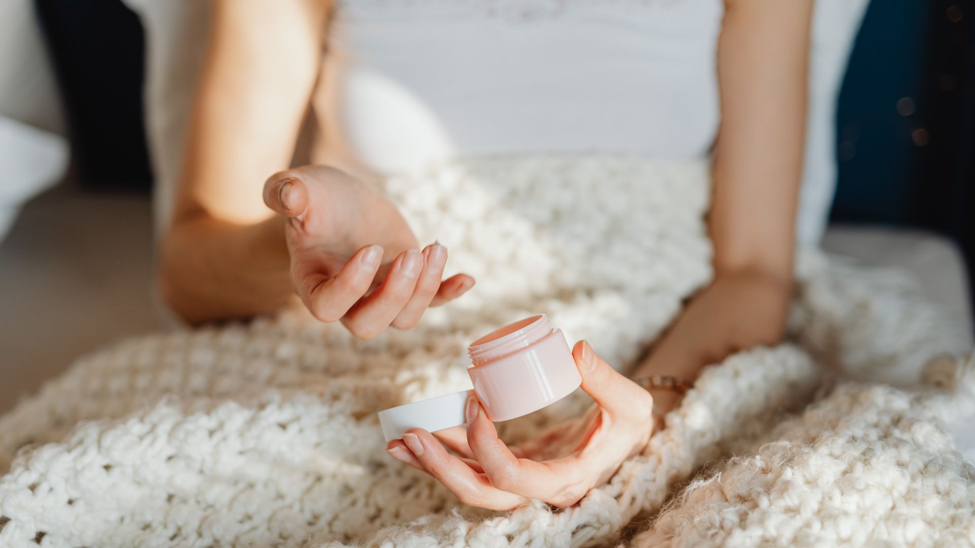 Moisturizer with spf jar in hands