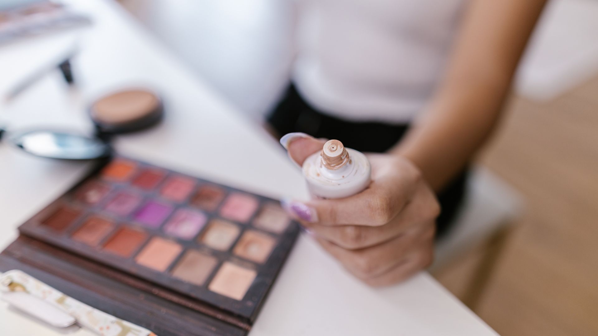 Tinted moisturizer tube in hand