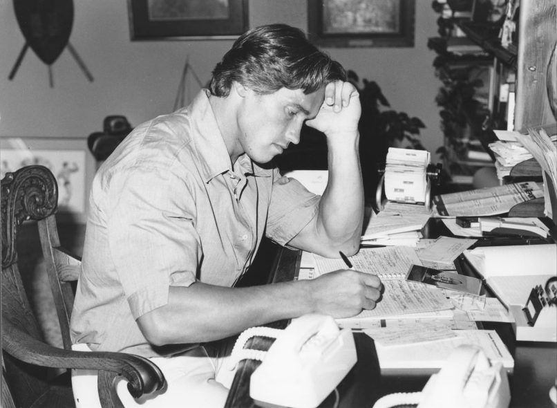 Arnold Schwarzenegger looks over some property papers